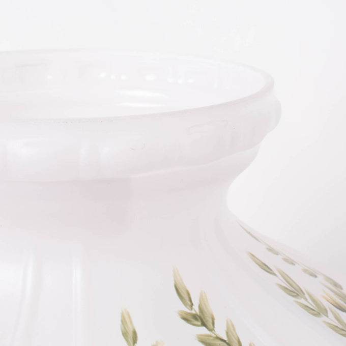 Handcrafted glass lamp shade in soft white with subtle green leaf accents, designed to gently diffuse light from oil lamps, featured in Lamps & Lighting and Best Sellers collections.