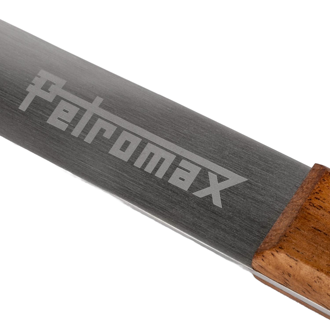 Close-up of a durable stainless steel serving spoon blade engraved with Petromax logo and attached to a hardwood walnut handle, handcrafted for Farm, Garden & Tool, Kitchen & Food, Camping, Storage and Serving, Best Sellers, and Promo Eligible collections.