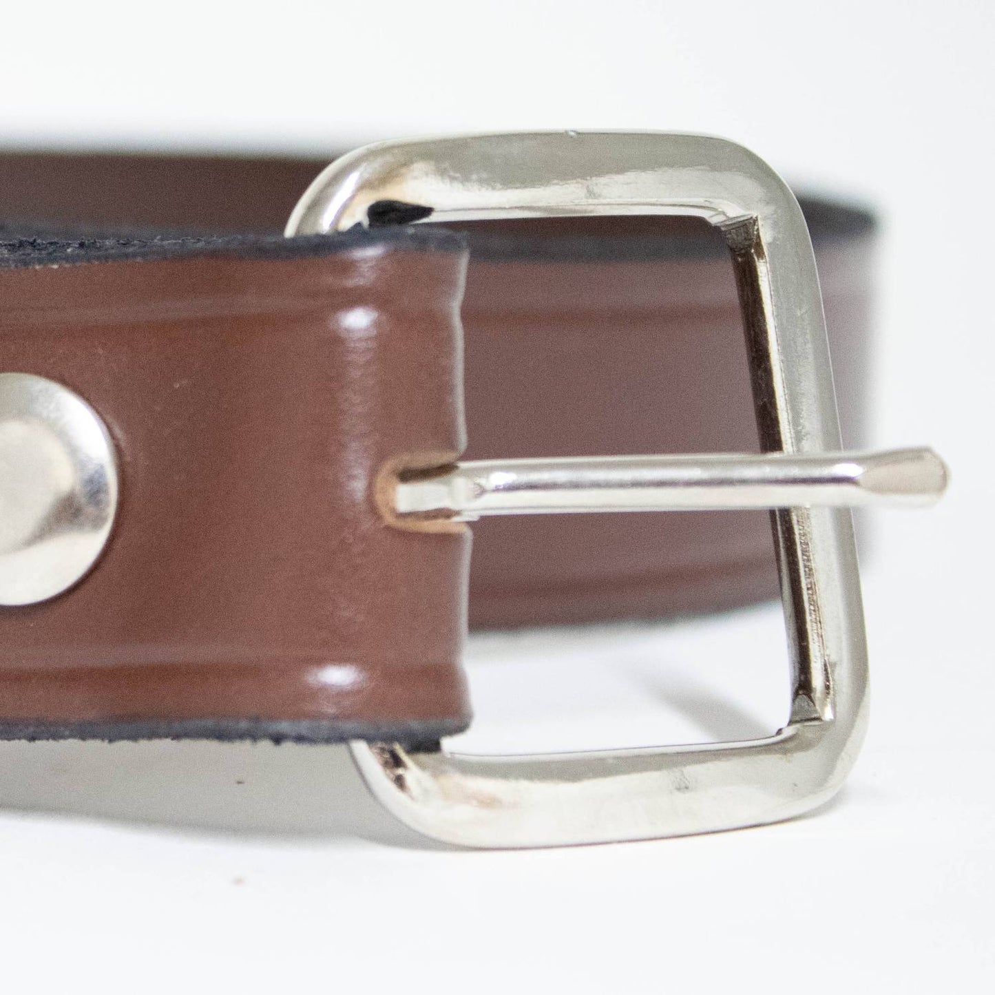 Close-up of a handcrafted Amish leather belt in smooth brown genuine cowhide with polished chrome buckle and metal snap fastener, part of USA Made, Amish Made, Health & Wellness, Clothing and Accessories, Best Sellers, and Promo Eligible collections.