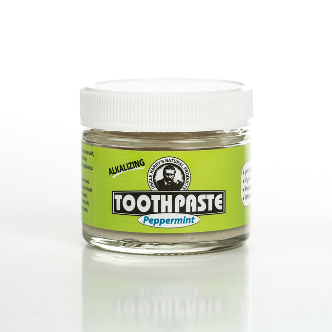 Small handcrafted glass jar of Uncle Harry's all-natural alkalizing peppermint toothpaste in a bright green label with white lid, featured in Health & Wellness, Grooming and Personal Hygiene, USA Made, Best Sellers, and Promo Eligible collections.