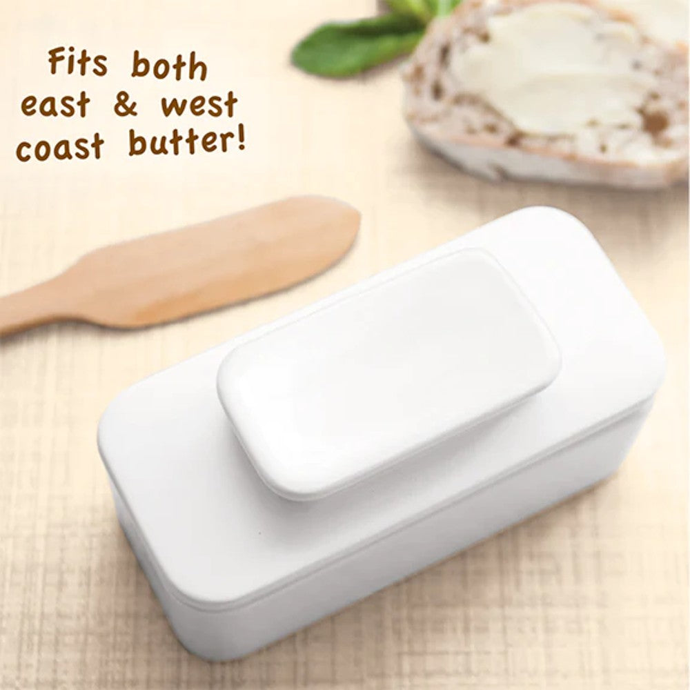 White ceramic butter keeper designed to hold a full quarter stick of butter with a fitted lid, shown with a wooden spreader and bread, part of Kitchen & Food and Specialty Equipment collections.