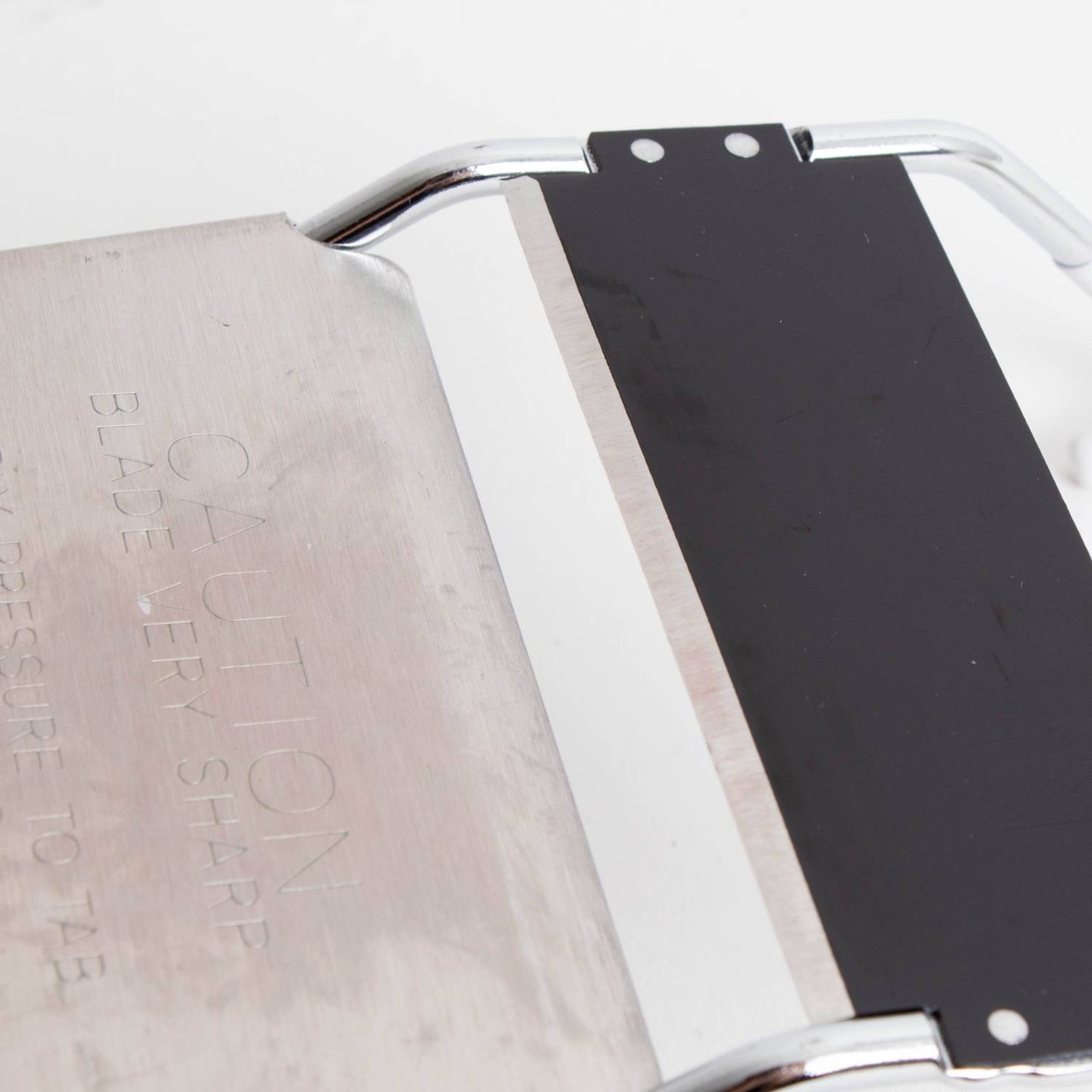 Close-up of a handcrafted vegetable slicer blade with sturdy metal frame, designed for uniform cuts, ideal for Kitchen & Food, Food Prep, Choppers and Cutters, Best Sellers, and Promo Eligible collections.