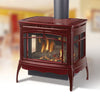 Large freestanding gas stove with three-sided glass panels and reflective interior glass, finished in deep red enamel, designed for efficient room heating in Stoves and Heatstoves collections.