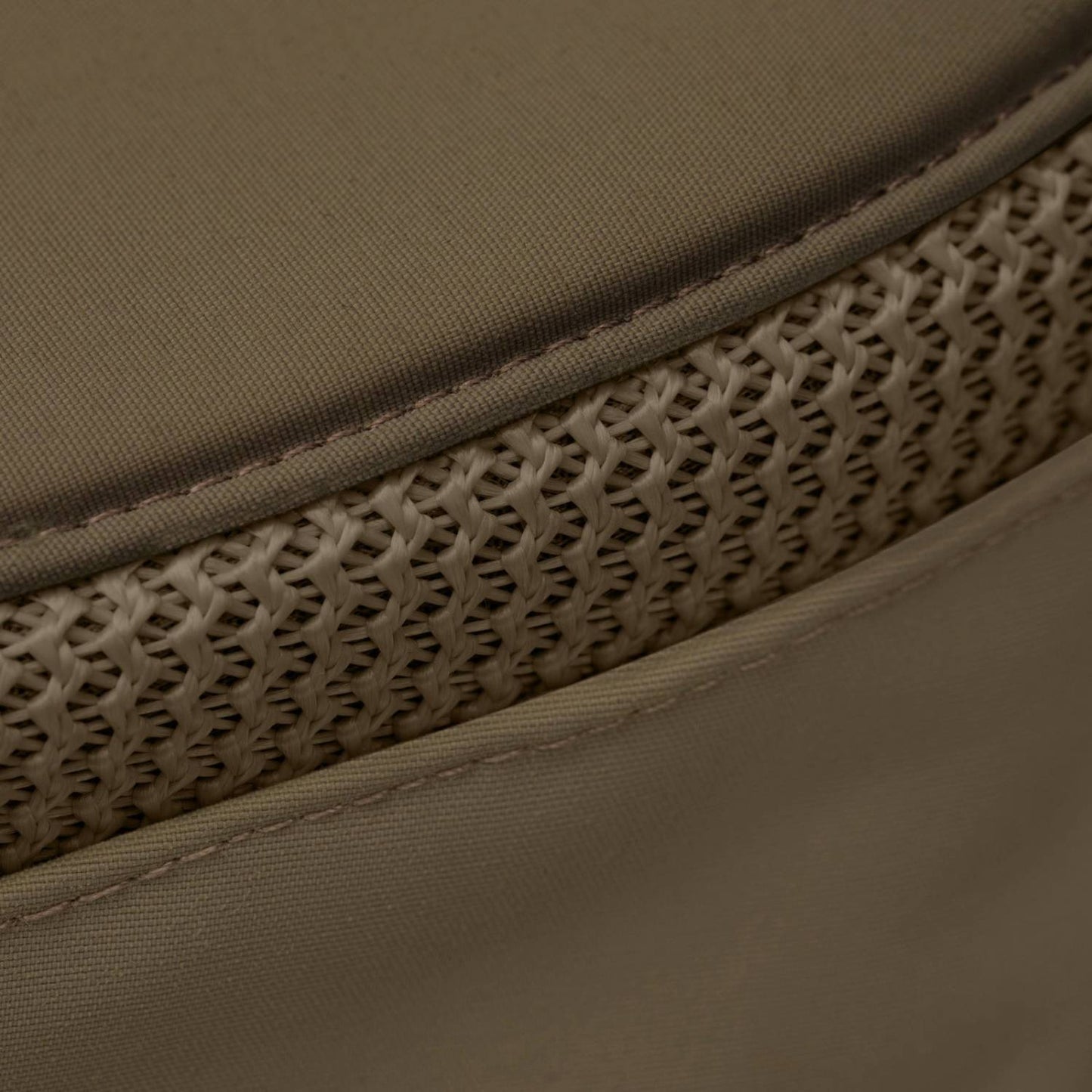 Close-up of olive-colored mesh ventilation integrated with durable fabric, highlighting breathable construction designed for comfort in gardening, camping, and health collections.