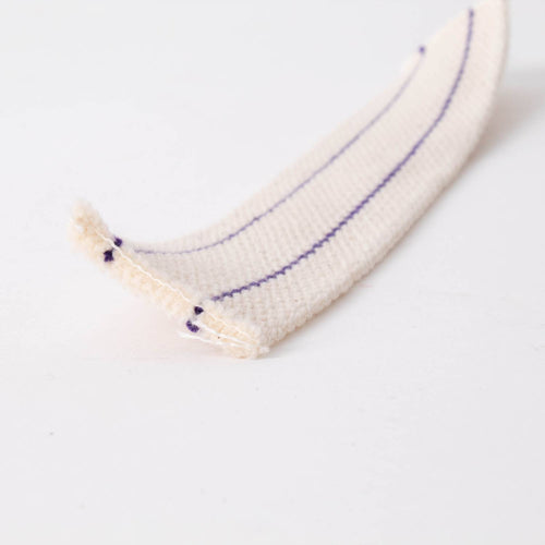Close-up of a white cotton flat wick with thin purple stripes, designed for oil lamps, featured in Lamps & Lighting, Oil Lamps, Table Lamps, Best Sellers, and Promo Eligible collections.