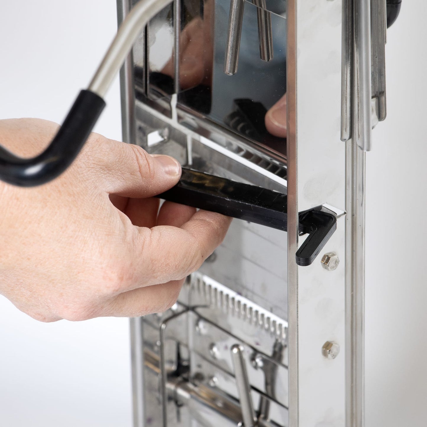 Close-up of hands adjusting the interchangeable blade mechanism on a stainless steel Lehman's Kitchen Mandoline Veggie Slicer, featured in Kitchen & Food and Food Prep collections.