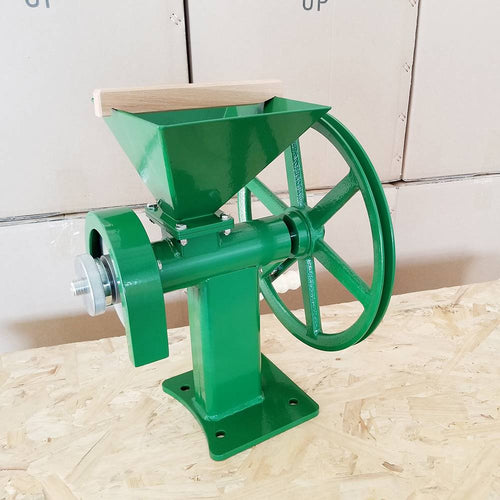 Green Power Grain Mill with sturdy green metal frame, large crank wheel, and wooden hand grip, featuring individually machined stainless steel burrs for Farm, Kitchen, and Emergency Supplies use.