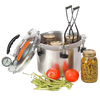 Stainless steel pressure canner with lid open and jars inside, accompanied by fresh green beans and tomatoes, designed for food preservation and pressure canning, made in USA.