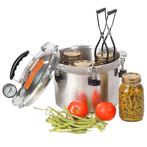 Stainless steel pressure canner with lid open and jars inside, accompanied by fresh green beans and tomatoes, designed for food preservation and pressure canning, made in USA.