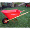 Bright red child's wheelbarrow with solid wooden handles, a durable metal frame, and rubber tire, displayed outdoors on grass, suitable for lawn games and toys collections.