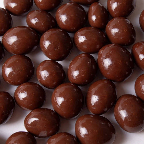 Close-up of glossy milk chocolate covered peanuts made with sugar-free chocolate, a handcrafted treat ideal for Kitchen & Food, Snacks and Sweets, Candy, USA Made, and Best Sellers collections.