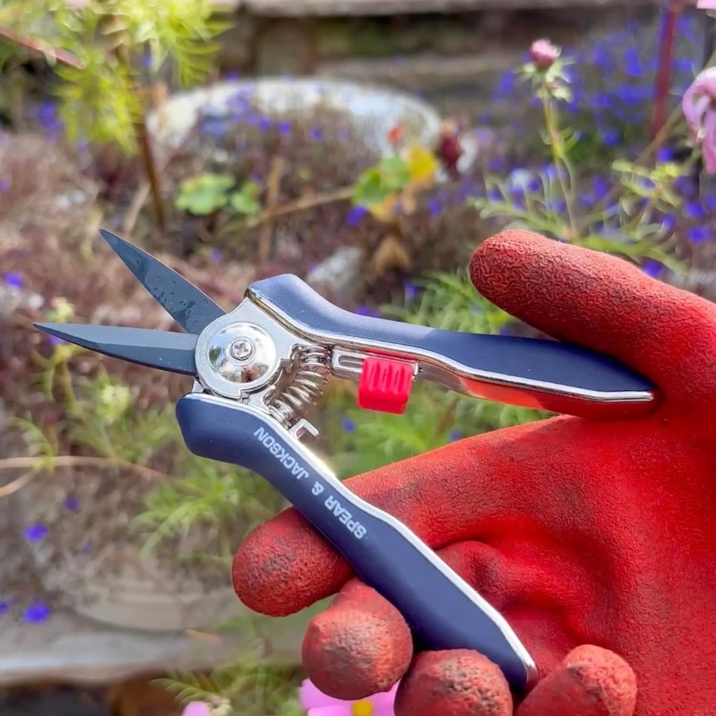 Hand holding a sleek pair of mini pruning shears with ergonomic handles, ideal for precise trimming in garden, lawncare, and farm tool collections.