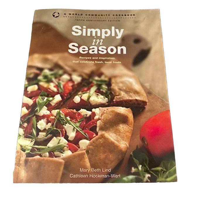 Cookbook cover featuring a rustic vegetable galette with fresh greens and cheese on parchment paper, highlighting a promotion for Simply in Season Expanded Edition in Cookbooks and Books collections.