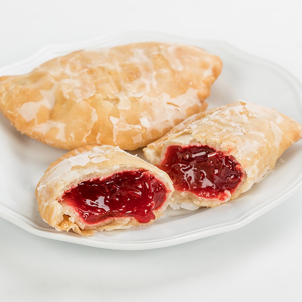 Handcrafted Amish-style fry pies with thick golden flaky crusts and luscious cherry filling, glazed lightly and served on a white plate, ideal for Kitchen & Food, Snacks and Sweets, Holiday Hosting, USA Made, Best Sellers, and Promo Eligible collections.
