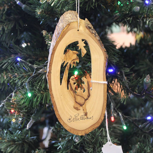 Handcrafted olive wood ornament featuring a bark slice with a nativity scene and palm silhouette, perfect for Home & Decor, Holiday Decor, Best Sellers, and Promo Eligible collections.