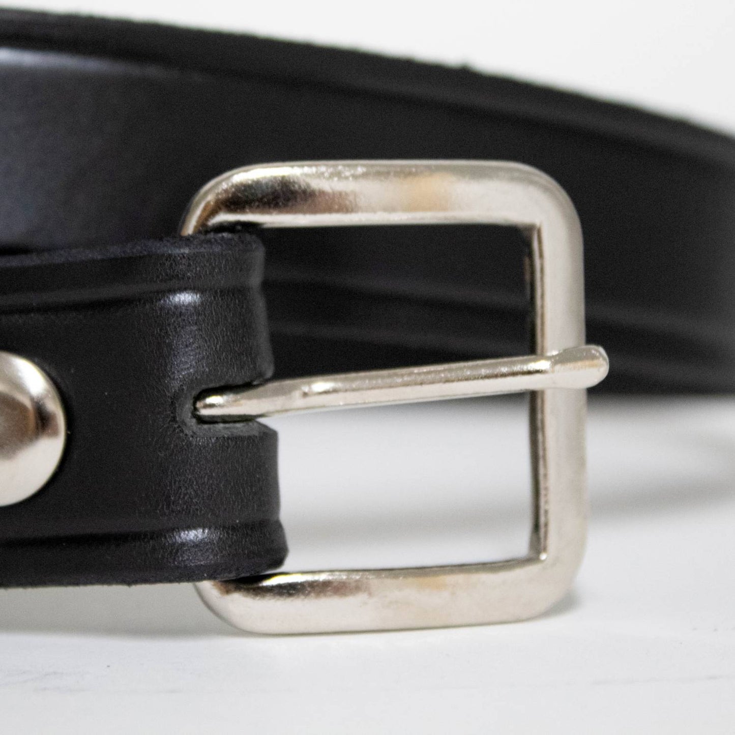 Handcrafted black genuine cowhide leather belt with a sturdy polished chrome buckle and snap fasteners, made in USA, featured in Health & Wellness, Clothing and Accessories, Amish Made, Best Sellers, and Promo Eligible collections.