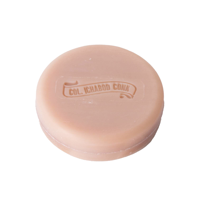 Large round shaving soap bar with embossed logo in soft almond hue, handcrafted in USA, nourishing with shea butter, avocado oil, and vitamin E. Part of Health & Wellness, Grooming and Personal Hygiene, Soaps and Soapmaking, USA Made, Best Sellers, and Promo Eligible collections.