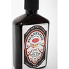 Dark amber bottle of handcrafted natural pine tar shampoo with vintage-style label, featuring pine cone design and highlighting soothing scalp care, from USA Made health and grooming collections.