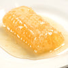Close-up of a rich, golden honeycomb filled with raw honey resting on a white plate, highlighting a natural, handcrafted treat perfect for Kitchen & Food, Pantry, and USA Made collections.