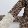 Close-up of a handcrafted arm of a brown and cream knit sock monkey made in USA, featured in Toys, Books & Games, Children's Toys, Indoor Play, and Best Sellers collections.