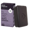 Handcrafted dark brown soap bar embossed with a stylized droplet and letter M, shown next to purple and black packaging highlighting bioactive eczema and psoriasis relief, part of Health & Wellness and Soaps collections.