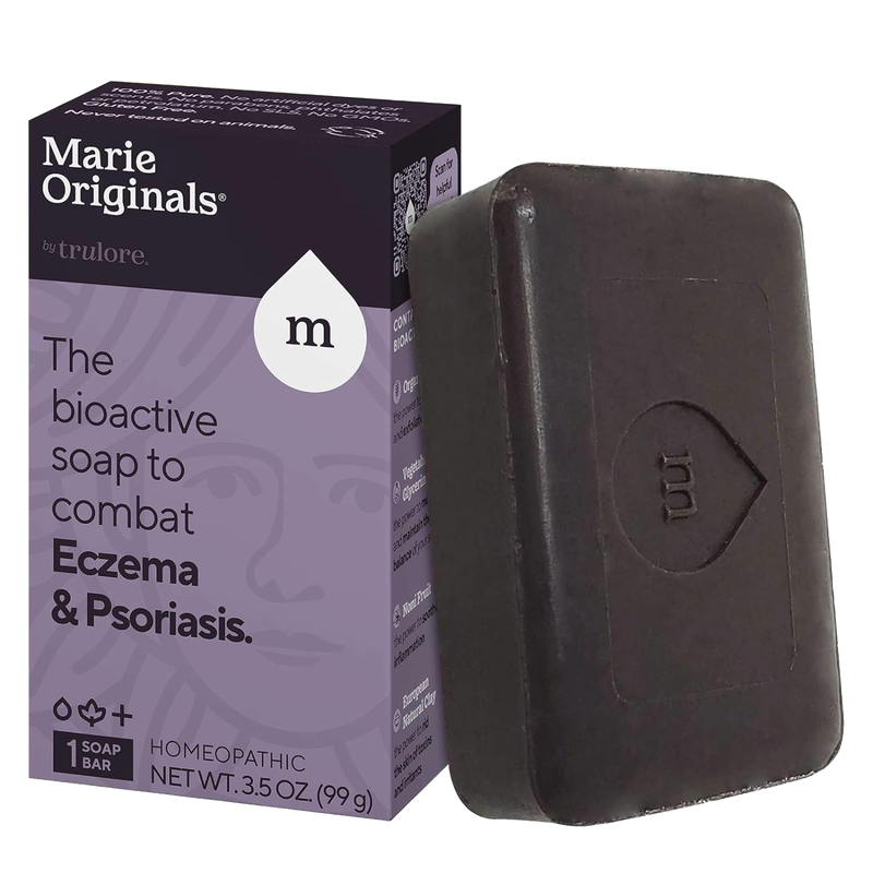 Handcrafted dark brown soap bar embossed with a stylized droplet and letter M, shown next to purple and black packaging highlighting bioactive eczema and psoriasis relief, part of Health & Wellness and Soaps collections.
