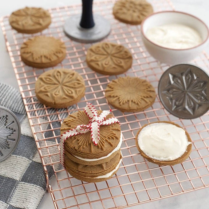 Thin-profile copper-plated cooling grid with a narrow square pattern displaying decorated cookies and frosting, perfect for Kitchen & Food, Baking Supplies, Cookware, and Promo Eligible collections.