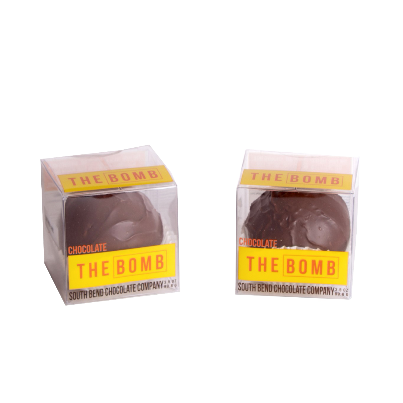 Two handcrafted chocolate hot cocoa spheres in clear boxes with bright yellow "THE BOMB" labels, made in USA, ideal for Kitchen & Food, Snacks and Sweets, Beverages, USA Made, Best Sellers, and Promo Eligible collections.