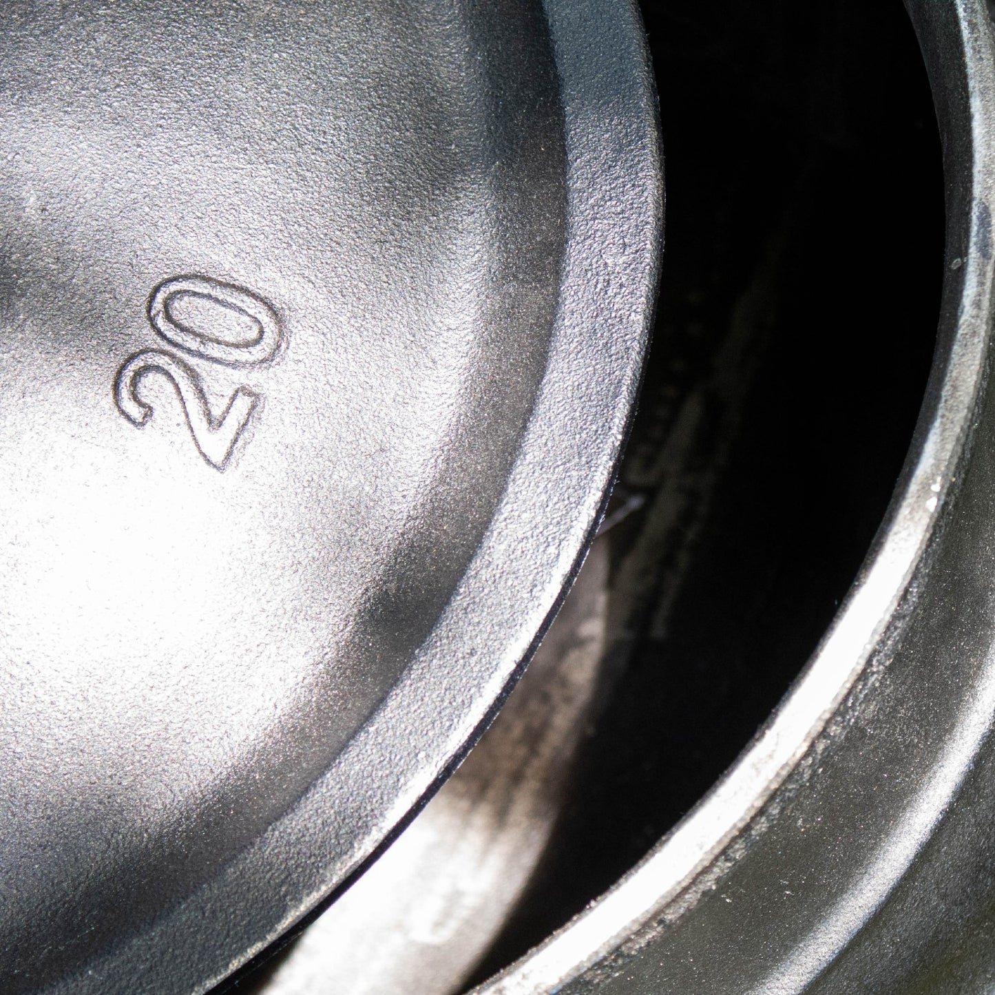 Close-up of the handcrafted cast iron kettle lid embossed with the number 20, showcasing durable construction for outdoor cooking in Farm, Garden & Tool, Camping, Best Sellers, and Promo Eligible collections.