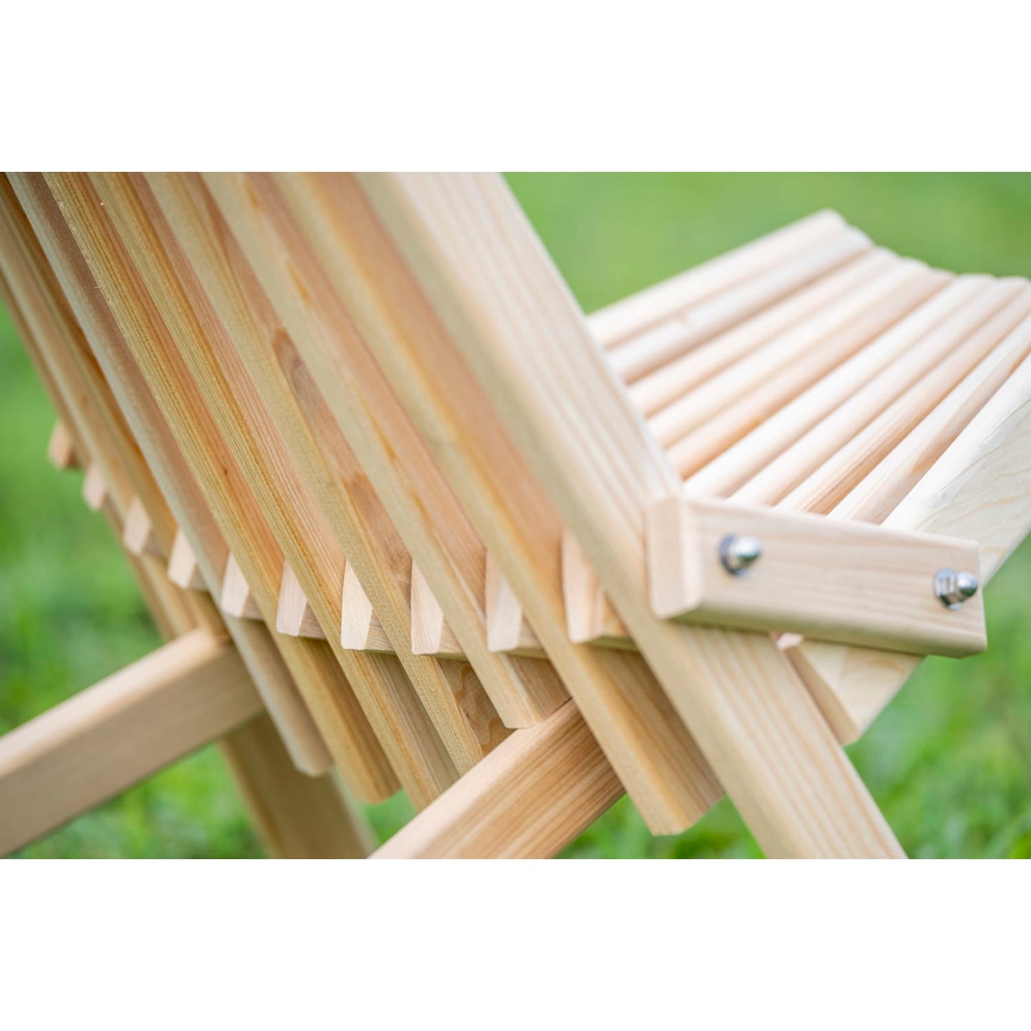 Close-up of handcrafted solid cypress wood folding chair showcasing smooth wooden slats and sturdy construction, perfect for outdoor furniture and camping collections, Amish made in USA.
