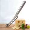 Sleek serrated stainless steel cheese knife with ergonomic handle, slicing through Swiss cheese beside fresh grapes and basil, part of Kitchen & Food and USA Made collections.
