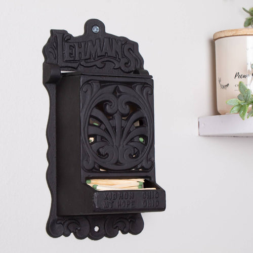Handcrafted black cast iron wall-mounted matchbox holder with intricate vintage-style scrollwork, embossed Lehman's branding, Amish made in USA, perfect for Home & Decor and Household Helpers collections.