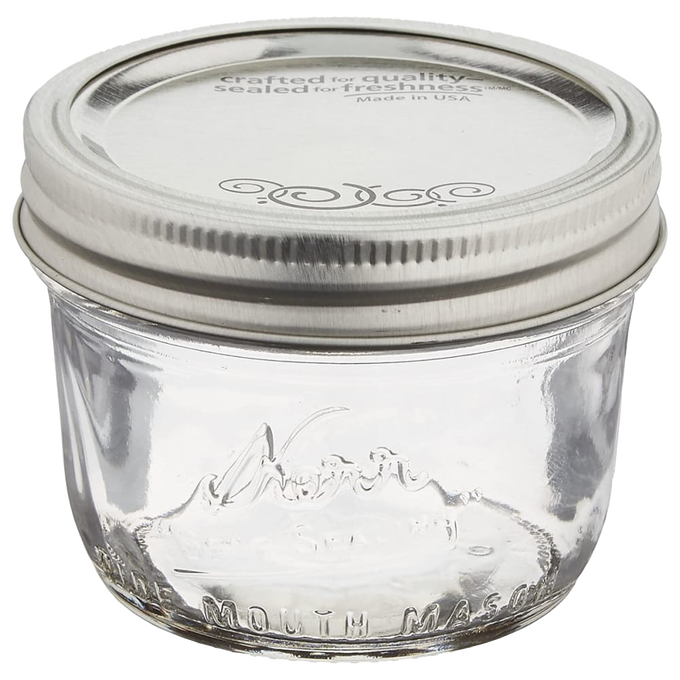 Clear glass half-pint canning jar with a wide mouth and silver lid, handcrafted in the USA, ideal for food preservation, crafts, and gift making in Kitchen & Food and Canning collections.