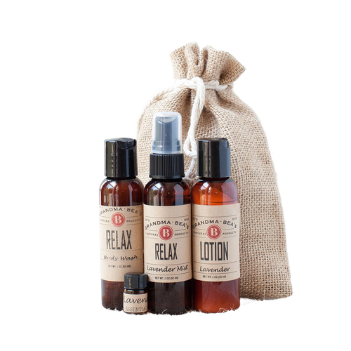 Handcrafted relaxation set featuring lavender lotion, body wash, mist spray, and essential oil in amber bottles with vintage labels, packaged in a rustic drawstring burlap bag, ideal for Health & Wellness, Grooming, Soaps, USA Made, and Best Sellers collections.