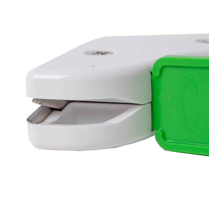 Compact garden tool sharpener with a white body and green handle, featuring a reversible diamond-honed tungsten carbide edge, made in USA for Farm, Garden & Tool and Lawncare collections.