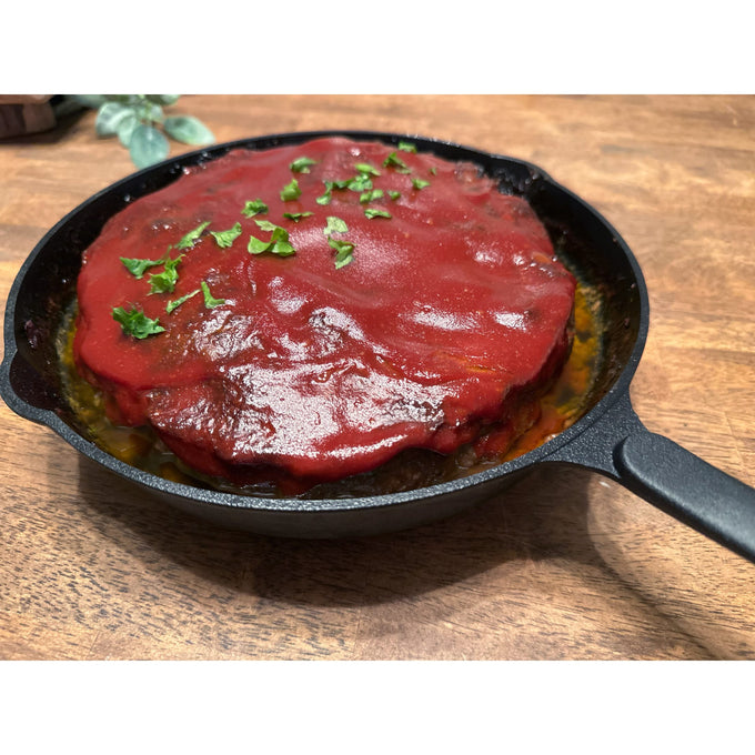 Handcrafted nitrogen-hardened cast iron skillet cooking a savory dish topped with rich tomato sauce and fresh chopped herbs, featured in Kitchen & Food, Cookware, Cast Iron, Best Sellers collections.