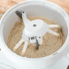White bowl scraper attachment gently scraping thick batter from the sides and inner post of a mixer bowl, a handcrafted USA made kitchen gadget for baking and cooking helpers collections