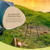 Rust-resistant steel frame bonfire builder standing on grass near camping chair and stacked firewood by a lakeside at sunset, ideal for Farm, Garden & Tool, Camping, and Best Sellers collections.