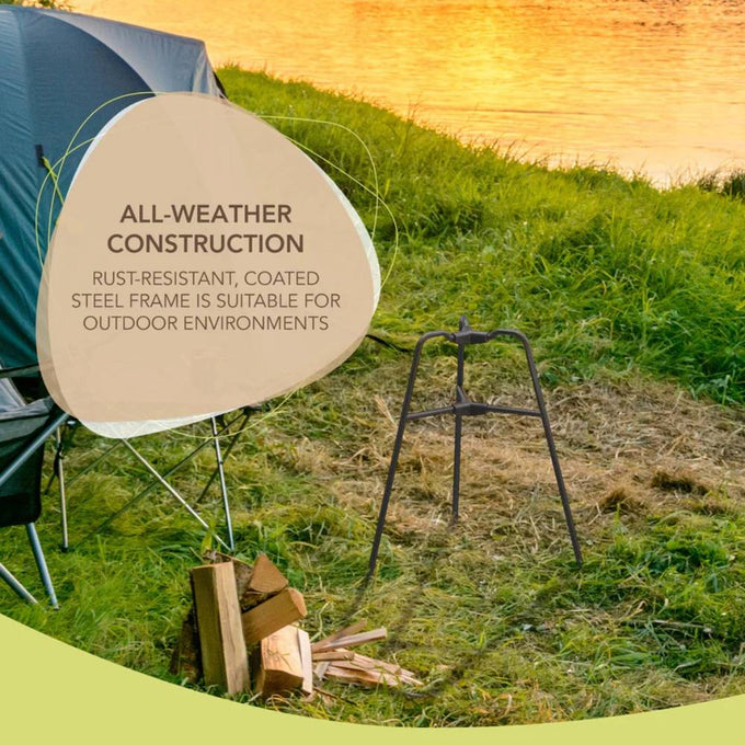 Rust-resistant steel frame bonfire builder standing on grass near camping chair and stacked firewood by a lakeside at sunset, ideal for Farm, Garden & Tool, Camping, and Best Sellers collections.