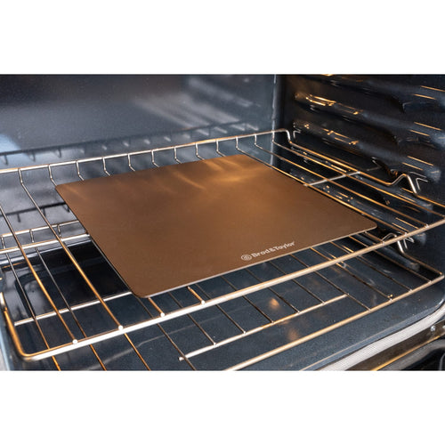 Slim durable bread steel placed on an oven rack, designed for even heat distribution and ideal for baking in Kitchen & Food, Cookware, Baking Supplies, and Best Sellers collections.