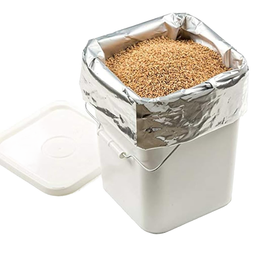 Large silver mylar bag filled with dry grains inside a white plastic container with lid off, ideal for long-term food storage, featured in Kitchen & Food, Grain Mills, USA Made, and Best Sellers collections.