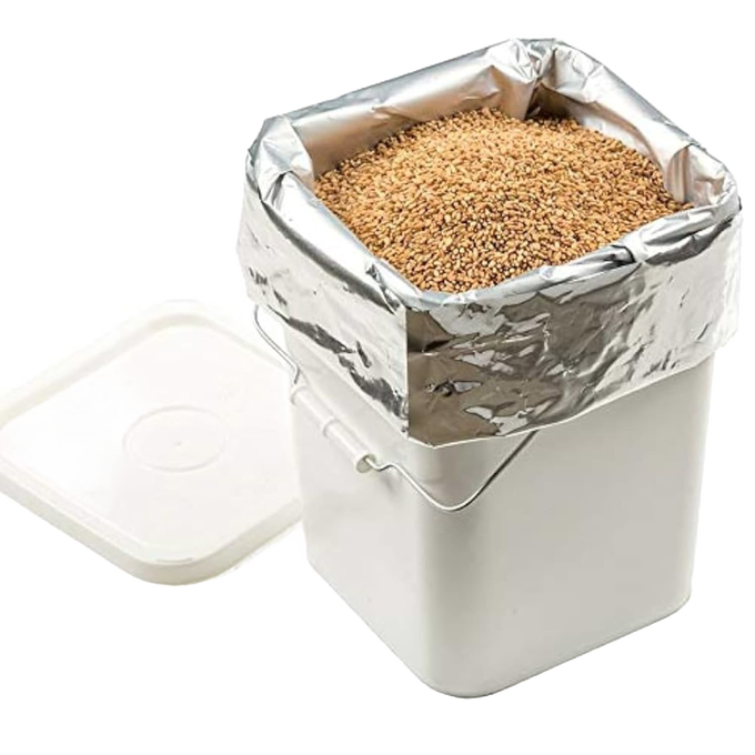 Large silver mylar bag filled with dry grains inside a white plastic container with lid off, ideal for long-term food storage, featured in Kitchen & Food, Grain Mills, USA Made, and Best Sellers collections.