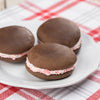 Three soft chocolate cake-like sandwiches with fluffy peppermint cream filling on a white plate, handcrafted in the USA, ideal for Kitchen & Food and Snacks and Sweets collections.