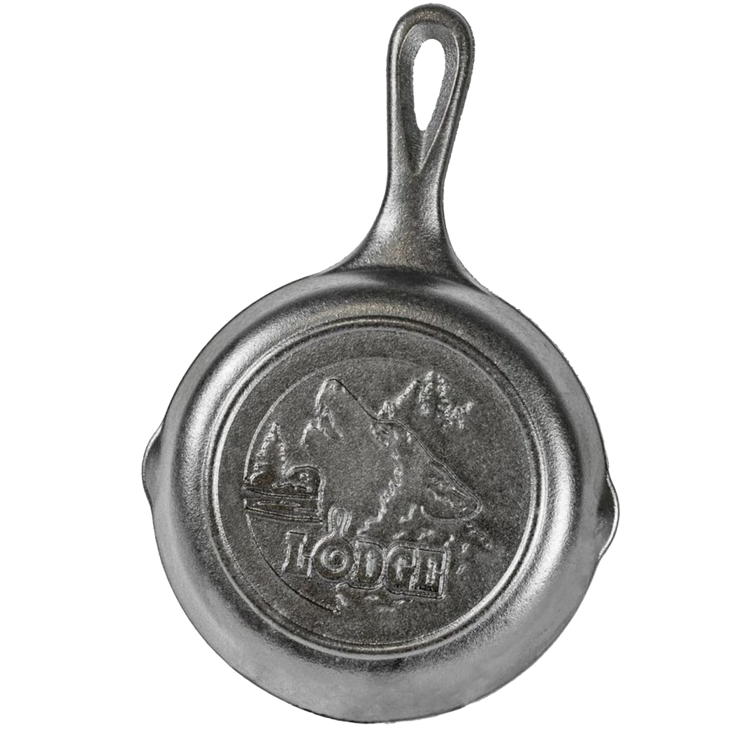 Small cast iron skillet with a raised wolf and mountain design on the bottom, made in the USA, ideal for Kitchen & Food, Cast Iron, Cookware, and Best Sellers collections.