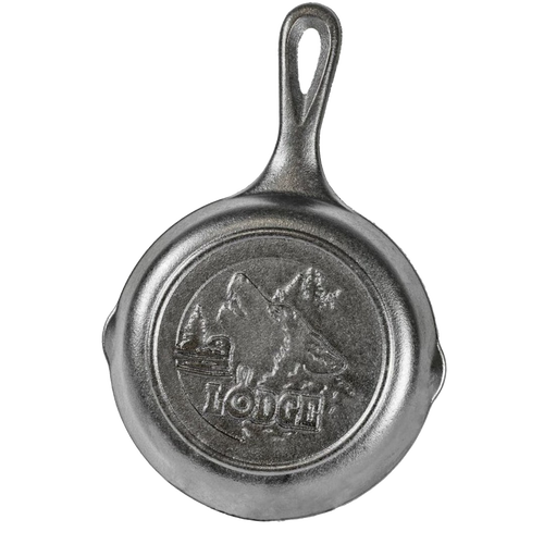 Small cast iron skillet with a raised wolf and mountain design on the bottom, made in the USA, ideal for Kitchen & Food, Cast Iron, Cookware, and Best Sellers collections.