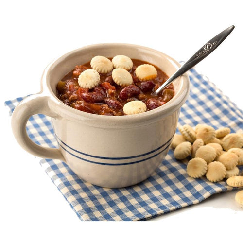 Handcrafted stoneware chili bowl with double blue stripes and handle, filled with chili and oyster crackers, sitting on a blue and white checkered cloth, ideal for Kitchen & Food, Dinnerware, USA Made, Best Sellers, and Promo Eligible collections.