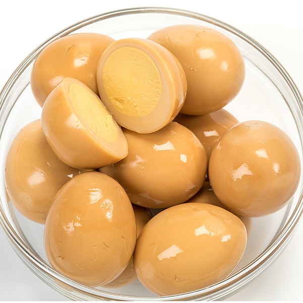 Clear glass bowl filled with glossy brown smoked eggs, one cut in half to show smooth firm yolk, ideal for Kitchen & Food, Food, Pantry, USA Made, Best Sellers, and Promo Eligible collections.