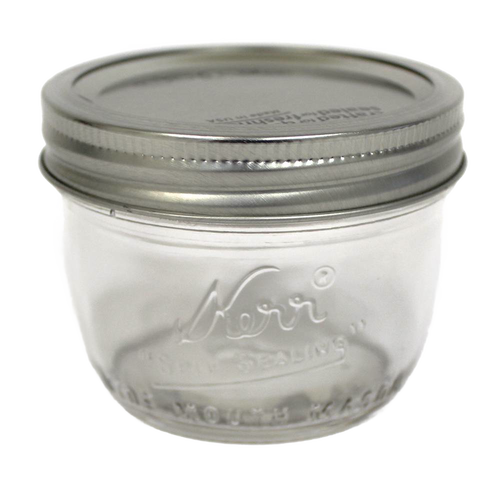 Clear glass wide mouth half-pint canning jar with silver metal lid, handcrafted and made in USA, perfect for food preservation, kitchen use, and crafts.