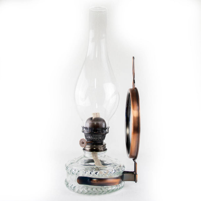 Reflector oil lamp with clear glass base, removable copper-toned mirror reflector, and tall glass chimney, handcrafted for Lamps & Lighting, Oil Lamps, Wall Lamps, Best Sellers, and Promo Eligible collections.