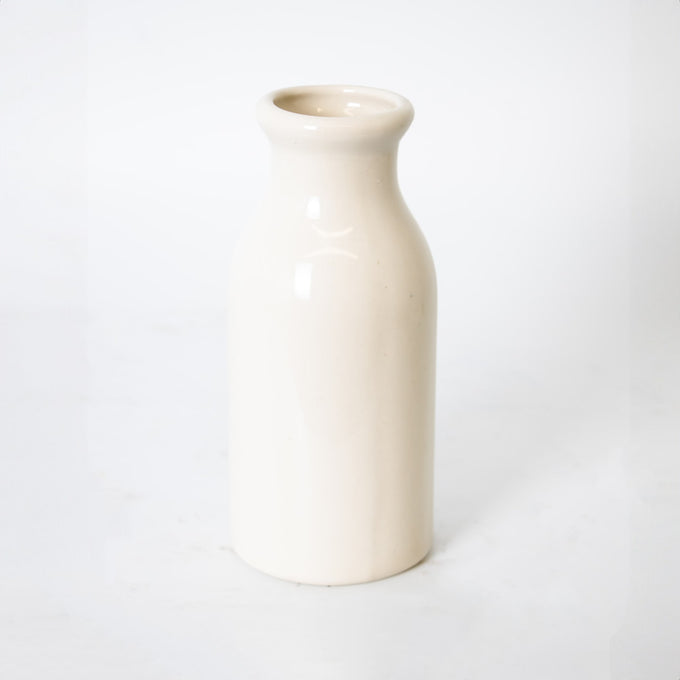 Handmade cream-colored stoneware milk bottle crafted in the USA, perfect for farmhouse-style kitchen decor, storage, and serving in Home & Decor collections.
